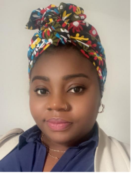 headshot of Evelyn. A Black woman wearing a colourful headscarf and a blue shirt